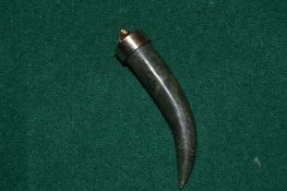 A natural jade tooth shaped pendant.