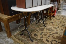 A cast iron and marble table.