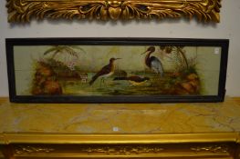 A late Victorian sixteen panel tile plaque depicting wading birds, flora and fauna, framed.