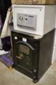 A Victorian cast iron safe with key together with a modern combination safe lacking key.