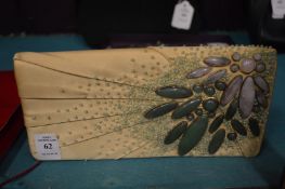 A silk clutch bag with hard stone decoration.