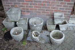 A quantity of reconstituted stone garden pots.