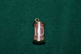 A 9ct gold emergency ten shilling note charm/pendant.