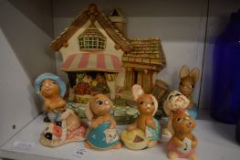 A Pendelfin shop or cottage selling baskets of fruit together with Pendelfin figures.