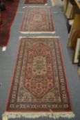 A pair of Persian style machine made rugs, 158cm x 83cm.