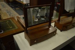 A Georgian mahogany dressing table mirror with three drawers to the bow fronted base.