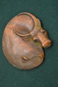 A small Chinese bronze scroll weight modelled as an oxon.