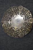 A pierced white metal dish, possibly silver.