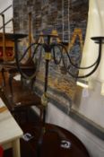 A wrought iron floor standing six branch candle holder.