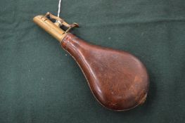 Brass and leather powder flask.