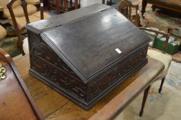 An 18th century oak bible box with carved decoration.