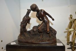 A bronze group of a fawn and goat on a marble base.