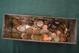 An old tin containing coins.
