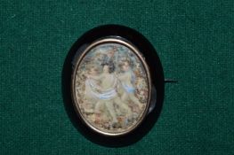 A brooch depicting cupids.