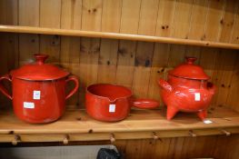 Three items of French red glazed pottery to include two twin handled pots and covers and a