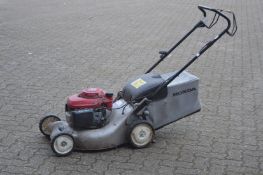 A Honda petrol rotary lawn mower.