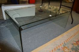 A stylish moulded glass coffee table.
