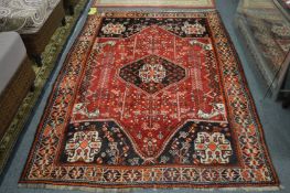 Persian design carpet, red ground with stylised decoration, 234cm x 156cm.