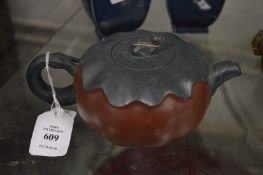A Chinese melon shaped Yixing teapot.