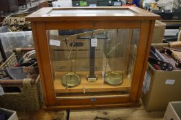 An oak cased set of scientific scales.