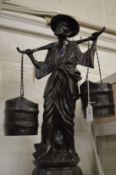 Cast bronze model of a Chinese water carrier.