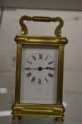 A brass carriage clock.