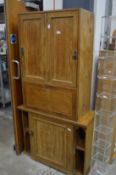 A pine two part cupboard.