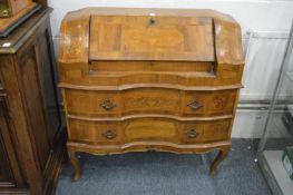 A Continental marquetry inlaid walnut bureau.