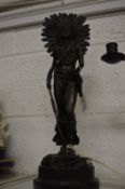 A cast bronze figure of an Indian squaw on a circular marble base.