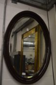 An oval wall mirror.