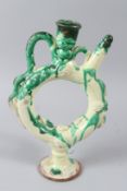 A TURKISH CANAKKALE POTTERY OLIVE OIL FLASK, with green slip decoration. 29cms high.