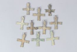A COLLECTION OF TWELVE SMALL BRONZE CROSSES. 4cms to 5cms long.