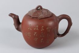 A CHINESE YIXING TEAPOT, 20TH CENTURY, of naturalistic form, with prunus tree and calligraphy