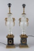 A PAIR OF CUT GLASS AND ORMOLU URN SHAPED TABLE LAMPS, with marble bases. 63cms high.