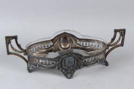 AN ART NOUVEAU WMF SILVER PLATED AND CUT GLASS OVAL SHAPED TWIN HANDLED BOWL. 47cms long.