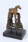 A SOUTH-EAST ASIAN BRONZE STATUE, four men holding a horse. 22cms high.