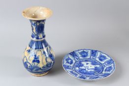 AN ISLAMIC CIRCULAR POTTERY DISH, painted to the centre with a recumbent deer; togethr with a