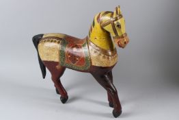 A DECORATIVE INDIAN CARVED AND PAINTED WOOD MODEL OF A STANDING HORSE. 47cms high.