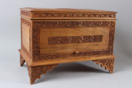 AN INDIAN SANDALWOOD CASKET, 20TH CENTURY, with hinged top above a drawer, on bracket feet, carved