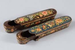 A PAIR OF MINIATURE ISLAMIC PAPIER MACHE PEN BOXES, with floral painted decoration. 13cms long.
