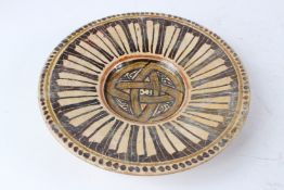 AN 11TH CENTURY ISLAMIC NISHAPUR CALLIGRAPHIC POTTERY DISH. 28cms diameter.