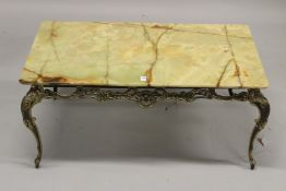 A RECTANGULAR ONYX COFFEE TABLE with ornate brass base. 95cms long x 52cms wide x 44cms high.
