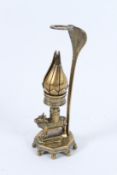 A 19TH CENTURY INDIAN BRASS LOTUS LAMP , an animal holding a flower. 21cms high.