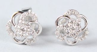 A PAIR OF 18CT WHITE GOLD DIAMOND CLUSTER EAR STUDS.