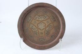 A DAMASCUS SILVER INLAID BRASS TRAY, circa 1900. 28cms diameter.