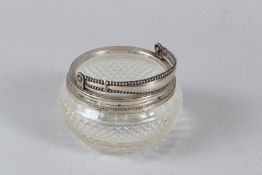 A SMALL SILVER MOUNTED CUT GLASS BASKET. 10cms diameter.
