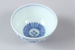 A JAPANESE BLUE AND WHITE PORCELAIN TEA BOWL, painted with flowers. 9.5cms diameter.