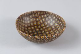 AN ISLAMIC AMBER AND BLUE GLASS CIRCULAR BOWL. 11cms diameter.
