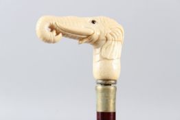 A WALKING STICK with carved bone handle as an elephant head. 92cms long.