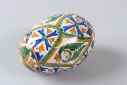 AN OTTOMAN TURKISH ARMENIAN GLAZED POTTERY HANGING OVOID BALL, painted with angelic faces and